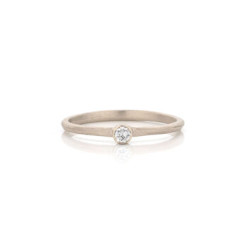 Organic champagne gold engagement ring with full matte finish and subtle diamond.