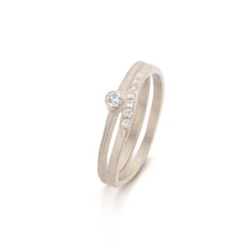 Playful champagne gold combination 16 of rings with small diamonds, larger diamond and matte finish.