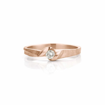 Rose gold engagement ring with matte finish with a diamond between two polished details.