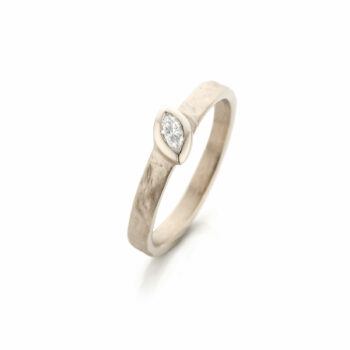 Marquise diamond engagement ring in white gold, with matte finish, and polished edges.