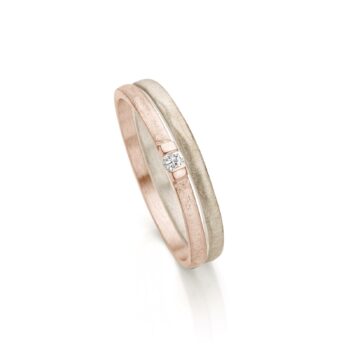 Simple combination in two colors of wedding and engagement ring in champagne with rose gold and with one diamond.