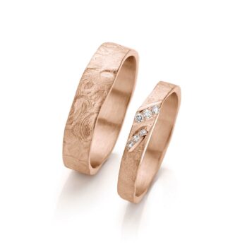 Handcrafted rose gold wedding rings with matte surface and six diamonds in the ladies ring.