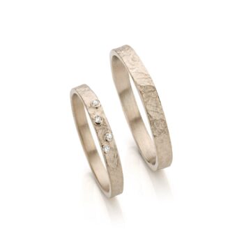 Handmade white gold wedding ring with four diamonds in the ladies ring.