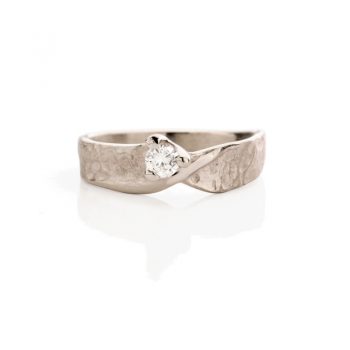 Enchanting white gold engagement ring with dented details, a matte finish, and polished accents.