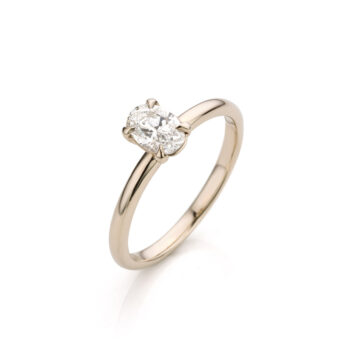 Classic oval-shaped engagement ring with an oval diamond, champagne-colored white gold, and fully polished, round finish.