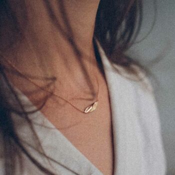 Simple rose gold necklace with pendant with matte and uneven surface.