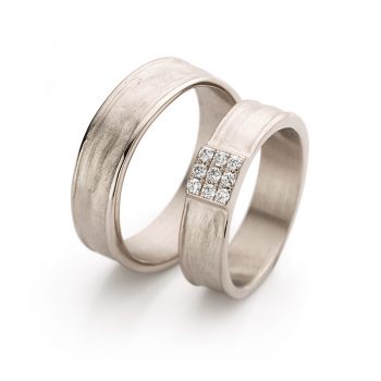 Classy white gold wedding rings with matte surface, polished edges and a square of three by three diamonds in the ring for ladies.